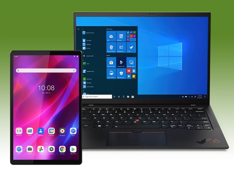 Tablet and laptop on green background