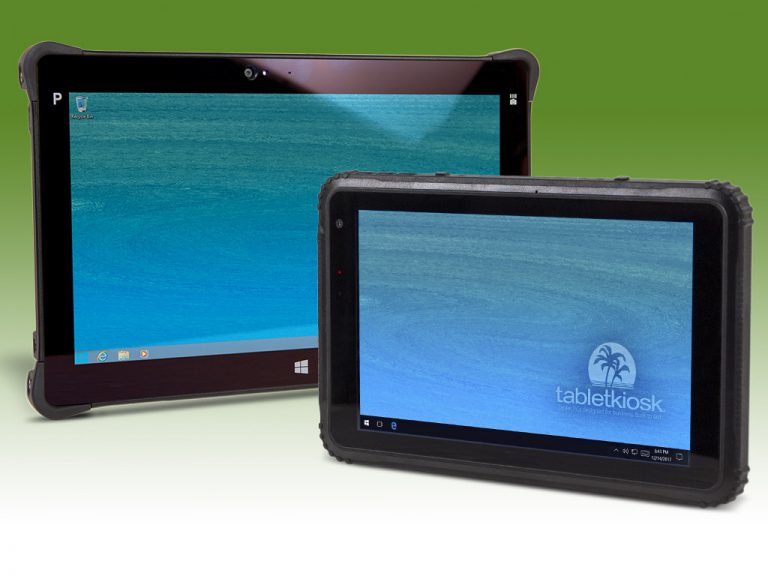 Two tablet devices on green background.