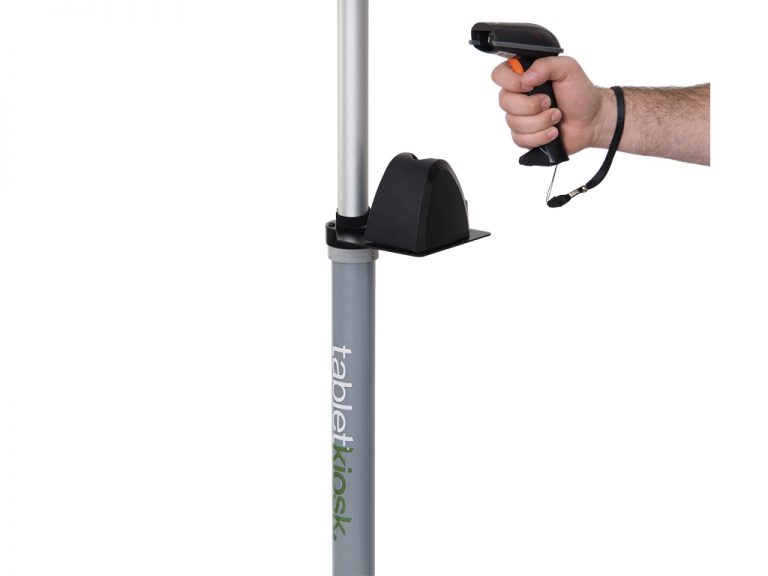 Hand holding barcode scanner near stand